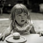 girl in front of cake